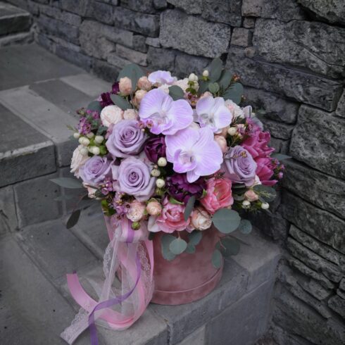 Luxury pastel orchid and rose flower box with pink Phalaenopsis orchids, blush and lavender roses, eucalyptus greenery in a pink hat box, Toronto and GTA flower delivery.