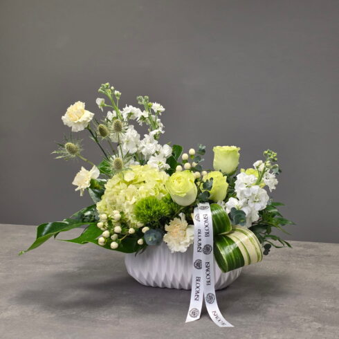 Luxury white and green floral arrangement in a modern ceramic pot with premium flowers and greenery in Toronto and GTA.