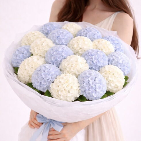 Blue and white hydrangea hand-tied bouquet with elegant wrapping by BLOOMSI
