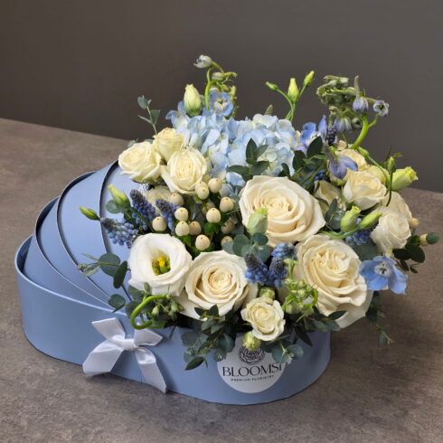 Elegant blue and white newborn flower arrangement in a BLOOMSI box for baby boy