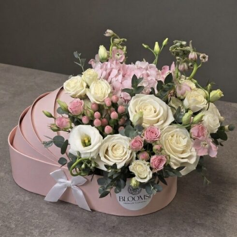 Soft pink newborn flower arrangement in BLOOMSI box for baby girl