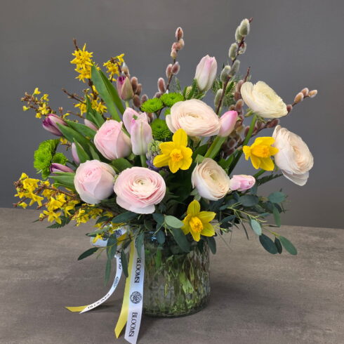 Spring garden flower arrangement with ranunculus, tulips and daffodils in glass vase – BLOOMSI Oakville Mississauga