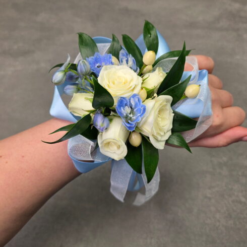 Blue and white luxury corsage bracelet with white roses and blue delphinium by BLOOMSI florist in Oakville and Mississauga