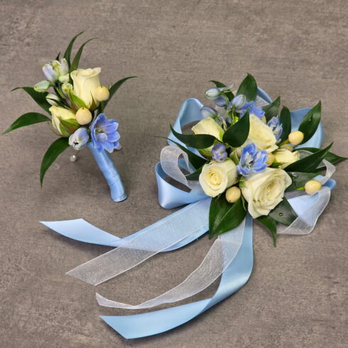 Luxury blue and white corsage and boutonniere set by BLOOMSI in Oakville and Mississauga with white roses blue delphinium and elegant ribbon styling