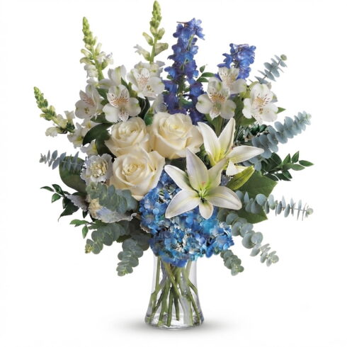 Luxury blue and white sympathy vase arrangement with hydrangeas lilies roses and eucalyptus by Bloomsi