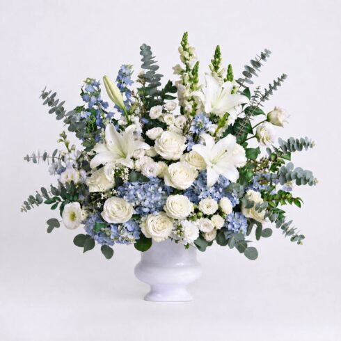 Luxury blue and white traditional funeral tribute with hydrangeas white roses lilies and delphinium by Bloomsi