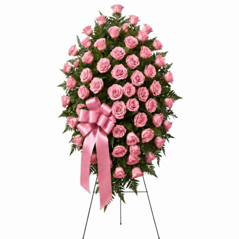 Luxury pink rose standing spray with premium roses greenery and pink ribbon by Bloomsi