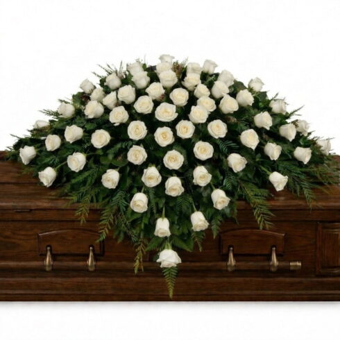 White Rose Casket Spray with premium roses and cascading greenery by Bloomsi