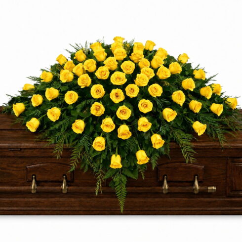 Yellow Rose Casket Spray with premium roses and cascading greenery by Bloomsi