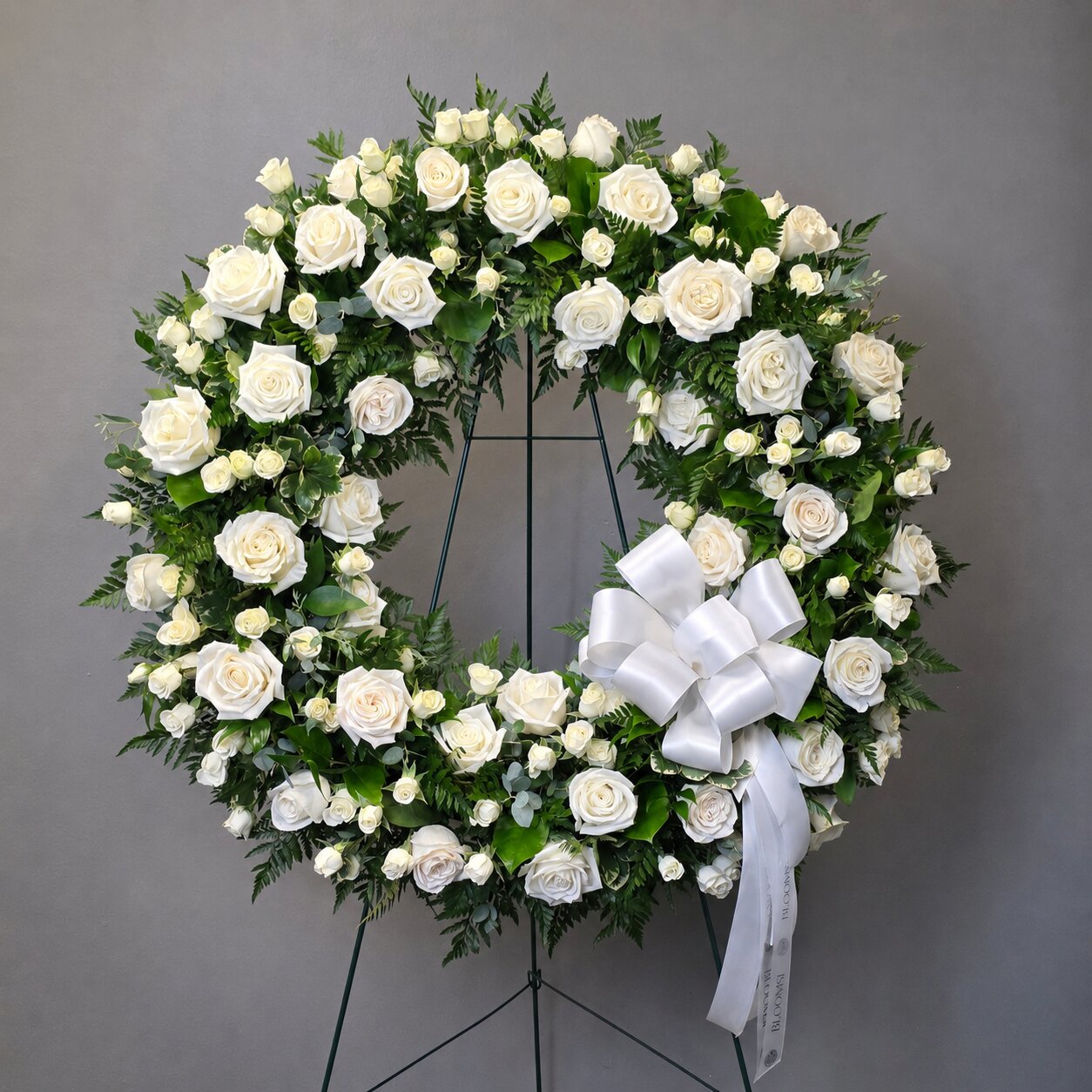 White rose funeral wreath for funeral flower delivery in Oakville and Mississauga by Bloomsi
